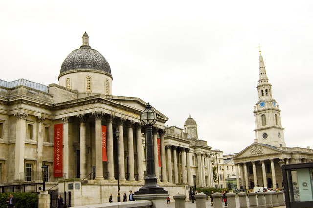 The main entrance of the National Gallery with its columned portico, is seen from Trafalgar Square with St Martin's in the Field church to the right.