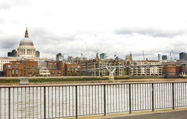 The thin Millennium Bridge goes across the Thames towards St Paul's Cathedral on the opposite bank.