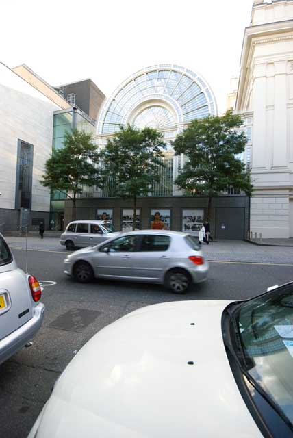 The curved glass and cast iron shape of the former Floral Hall can be seen behind the trees with the Royal Opera House on the right.