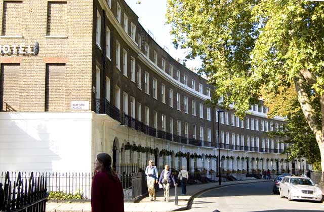 The pictures shows an elegant early 19th century crescent in Bloomsbury curving around with trees and a garden in the middle.