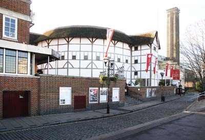 The Globe Theatre is circular with black and white walls and a thatched room. 